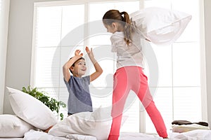 Happy children having pillow fight