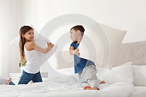 Happy children having pillow fight