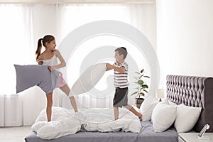 Happy children having pillow fight