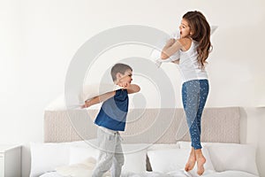 Happy children having pillow fight