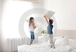 Happy children having pillow fight