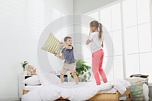 Happy children having pillow fight