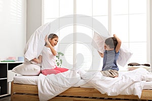Happy children having pillow fight