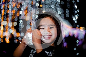 Happy children Holding a light on a New Year`s Eve.Street Night