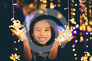 Happy children Holding a light on a New Year`s Eve.Street Night