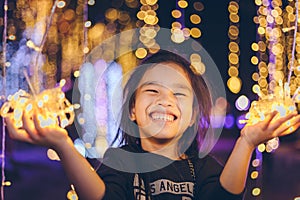 Happy children Holding a light on a New Year`s Eve.Street Night