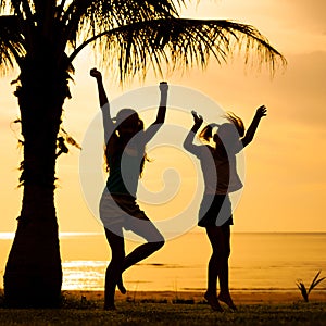 Happy children jumping on the beach