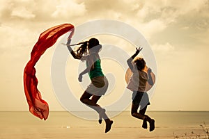 Happy children jumping on the beach