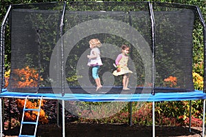 Happy children jumping on trampoline photo