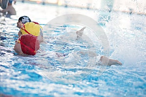 Happy children kids group at swimming pool class learning to swim