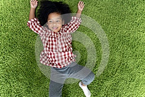 Happy children kids smiling and laying on green carpet floor in living room at home.