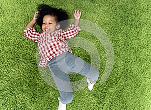 Happy children kids smiling and laying on green carpet floor in living room at home.