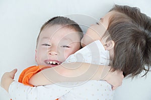 Happy children, laughing kids hugging each other, closeup portrait of boy and little girl