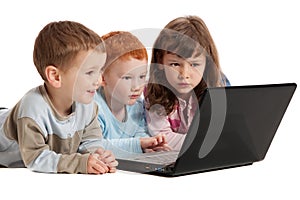 Happy children learning on kids notebook computer