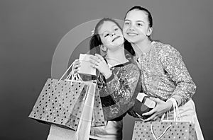 Happy children. Little girl sisters with gift box. Small girls with shopping bags. Sales and discounts. Sisterhood