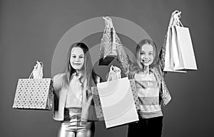 Happy children. Little girl sisters. Small girls with shopping bags. Sales and discounts. Sisterhood and family. savings