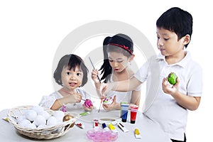 Happy children painting easter eggs