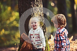 Happy children play in autumn forest. Happy family, friendship, love and trust