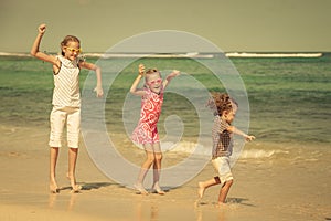 Happy children playing at the beach
