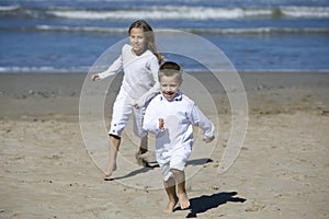 Happy children playing at the beach