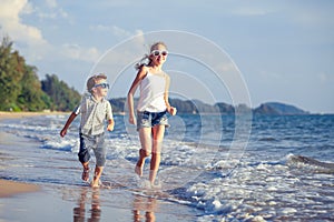 Happy children playing on the beach at the day time.