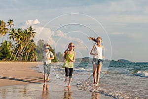 Happy children playing on the beach at the day time.