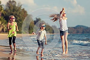 Happy children playing on the beach at the day time.