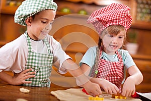 Happy children playing chef in the kitchen