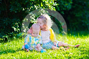 Happy children playing in the garden with toy balls