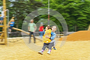 Happy children playing and having fun at playground