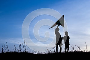 Happy children playing on nature summer silhouette