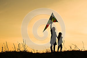 Happy children playing on nature summer silhouette