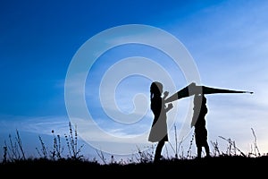 Happy children playing on nature summer silhouette