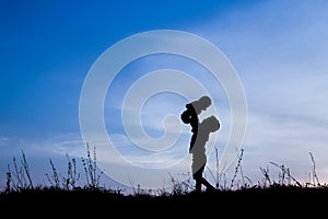 Happy children playing on nature summer silhouette