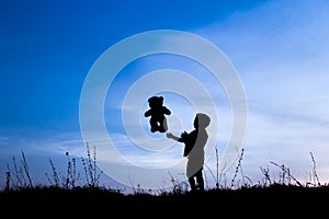 Happy children playing on nature summer silhouette