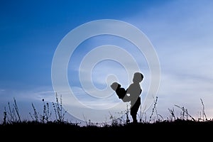 Happy children playing on nature summer silhouette