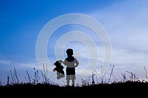 Happy children playing on nature summer silhouette