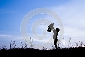 Happy children playing on nature summer silhouette