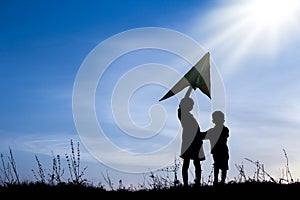 Happy children playing on nature summer silhouette