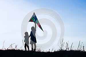 Happy children playing on nature summer silhouette