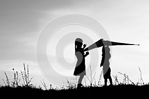 Happy children playing on nature summer silhouette