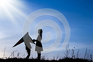 Happy children playing on nature summer silhouette