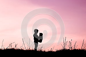 Happy children playing on nature summer silhouette