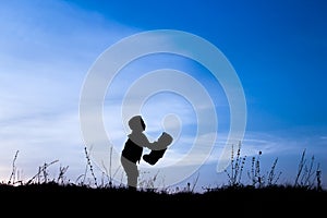 Happy children playing on nature summer silhouette