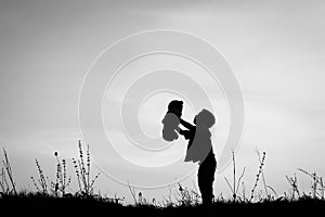 Happy children playing on nature summer silhouette