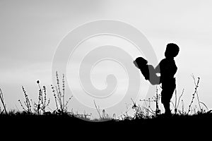 Happy children playing on nature summer silhouette