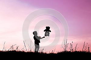 Happy children playing on nature summer silhouette