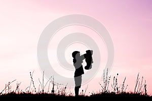 Happy children playing on nature summer silhouette