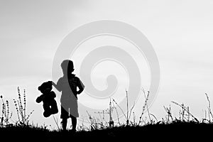 Happy children playing on nature summer silhouette