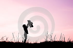 Happy children playing on nature summer silhouette